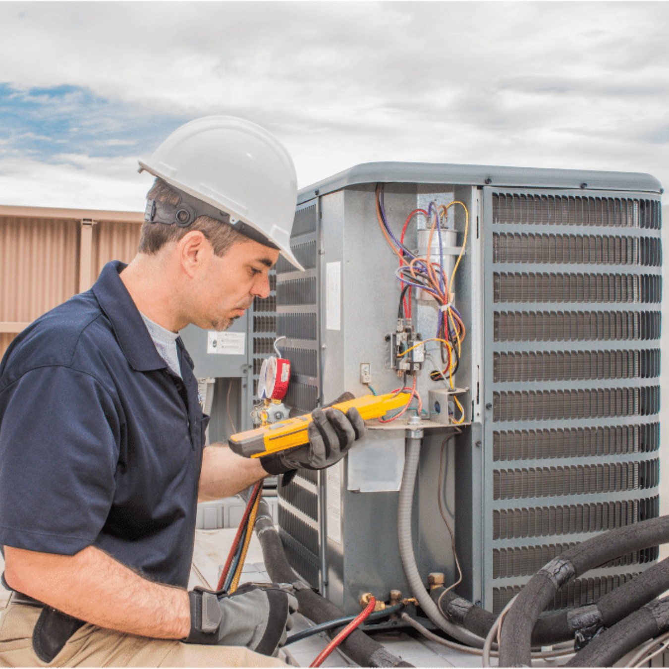 Aylmer Heating & Cooling HVAC technician servicing a system